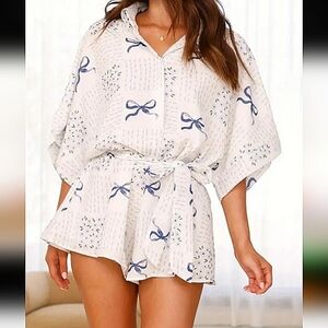 NWT collared blue and white short-sleeved button-up romper, size large.